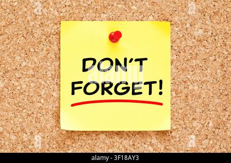 Handwritten message Do Not Forget on yellow sticky note. Concept about reminder, keeping in mind, remembering or schedule. Stock Photo