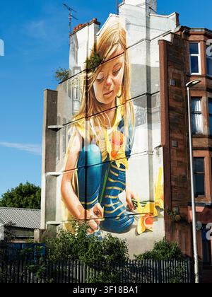 Glasgow, UK, June 24th 2026, Girl and flower mural on building wall in Govan Stock Photo