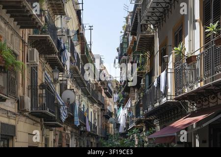 Closely lined balconies of an old town street with clotheslines, Palermo, Sicily, Italy Stock Photo