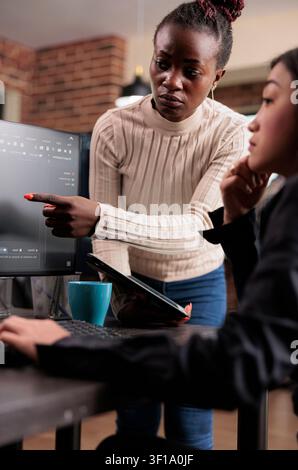 Software developer points at cloud database error with code, databases and network security work focused on data protection, firewalls and software development Stock Photo