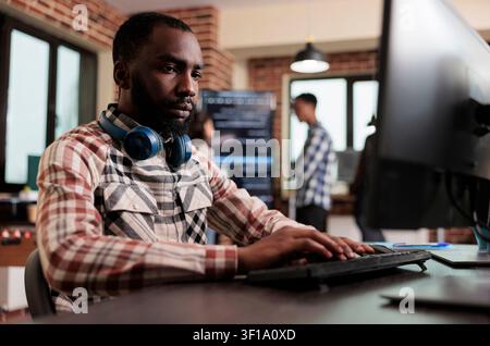 Cyber developer creating encrypted node network system African american programmer developing high security application with multiple layers of scalability. Stock Photo