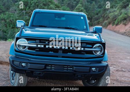 The Ford Bronco in Azure Gray Metallic sits perched off a fire road in the back country of Arizona Stock Photo