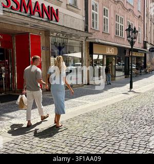 A couple holds hands while strolling in Prague, Czechia. Stock Photo