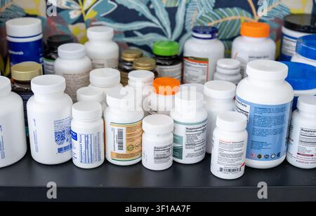 Hollywood, Florida, USA - June 26 2026: The plastic bottles and the jars with the vitamins and the nutritional supplements stand in a row. Stock Photo