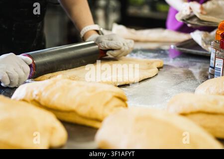 Baker Folding Sourdough Dough by Hand on Stainless Steel Stock Photo