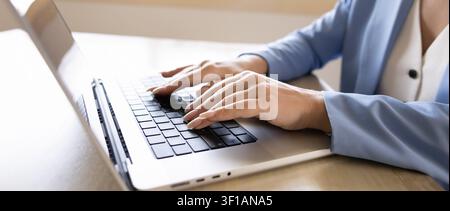 Closeup of businesswoman typing on laptop keyboard Stock Photo