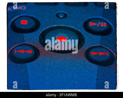Stylized macro of media control buttons with glowing red icons on a textured blue device panel with a vintage film border Stock Photo