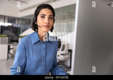 Portrait of focused support agent working at computer monitor Stock Photo