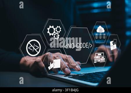 No-code software development and visual programming concept. Programmer using laptop with NO-CODE icons, prohibited coding sign, app builder, Stock Photo
