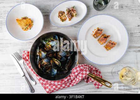 Overhead seafood table with mussels and assorted gourmet appetizers Stock Photo