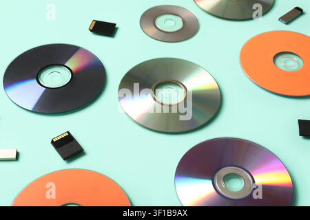 Composition with CD disks, USB flash drives and SD cards on turquoise background Stock Photo