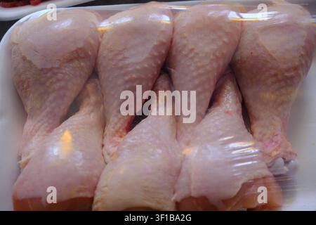 Packaged raw chicken drumsticks and minced beef in plastic trays Stock Photo