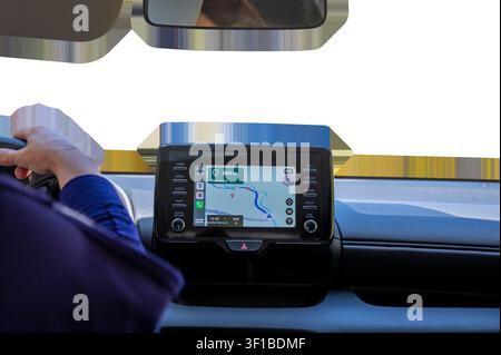 Driver hand on steering wheel with car navigation system dashboard screen displaying map, vehicle interior isolated on transparent background. High qu Stock Photo