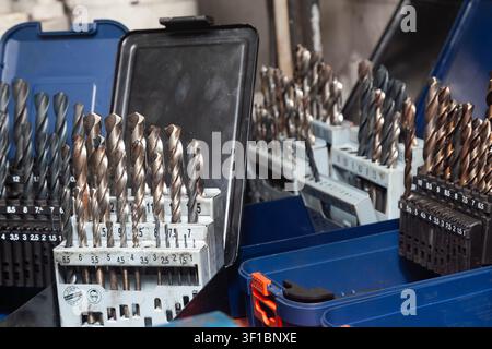Sets of drills on a table in a workshop Stock Photo