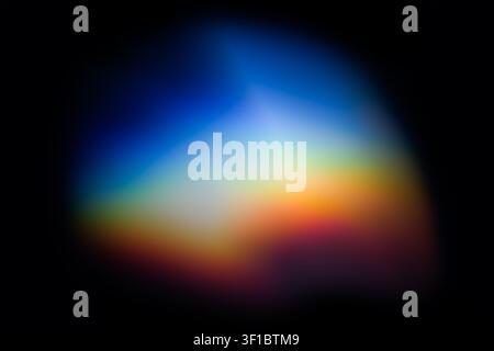 Abstract light refraction creating blurred colorful spectrum on dark background Stock Photo