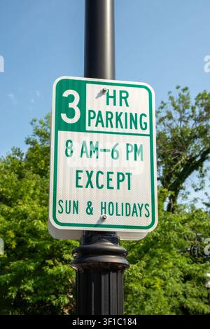 Three-hour parking sign displaying municipal parking restrictions on a decorative street lamp in New Jersey. Stock Photo