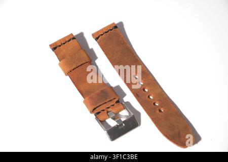 Close-up of premium genuine brown leather watch strap with detailed stitching and metal buckle Stock Photo