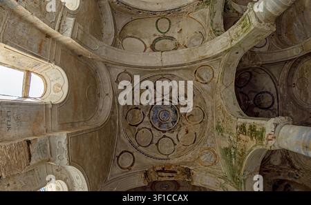 Painted ceiling domes, arches and vandalized walls of St Nicholas Church. Gullubahce, Soke, Aydin, Turkey - October 13, 2019 Stock Photo