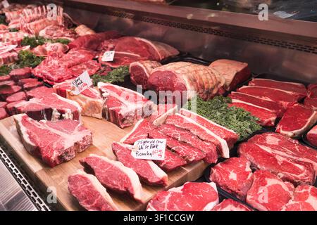 Raw beef steaks on display at a butcher shop counter Stock Photo