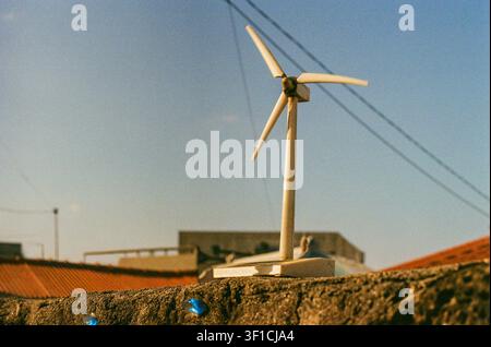 Small Wind Turbine Model on an Urban Rooftop Stock Photo