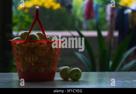 Apples in a plastic basket on the table Stock Photo
