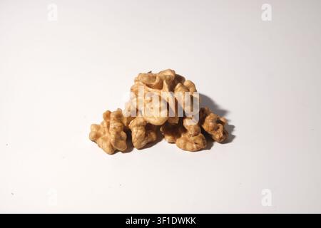 Shelled walnut halves arranged on white background close-up Stock Photo