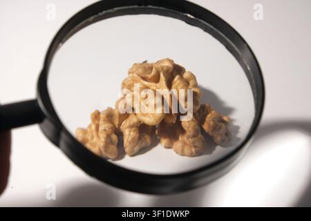 Shelled walnut halves arranged on white background close-up Stock Photo