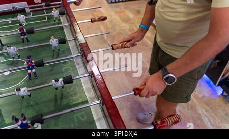 Man Playing Table Football Foosball Game Close Up Indoors Stock Photo