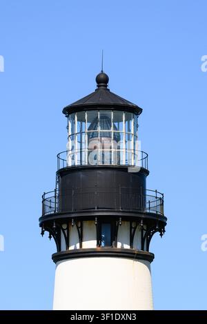 Newport, OR, USA - June 11, 2026; Detail of top of Yaquina Head Lighthouse isolated on blue sky Stock Photo
