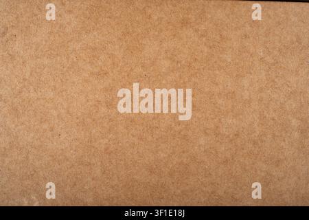 Uniform texture of kraft paper or cardboard for eco friendly packaging. Stock Photo