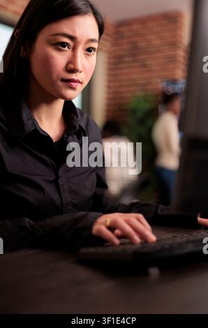 System engineer developing a company software project in a programming workspace, connecting source code, database logic and collaborative development for a technology project. Stock Photo