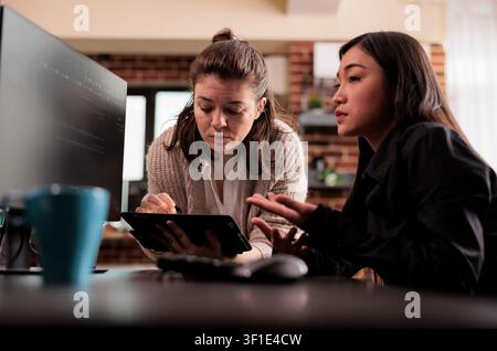 Diverse programming engineers analyzing html code on computer, planning artificial intelligence project, web developers working on machine learning software, developing new interface. Stock Photo