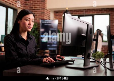 Freelance coder programming server code algorithm on computer, typing server data in it agency office, programming engineer working on new user interface with online system to create algorithm. Stock Photo