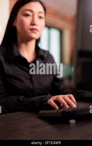 Software developer programs server code at a computer desk in an IT agency, focused on HTML algorithms and digital development workflow. Stock Photo