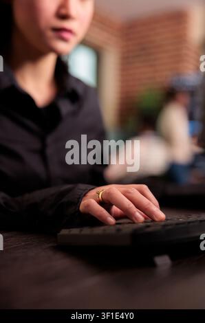 Freelance coder programs a server algorithm at a computer desk, building software code and development logic in an IT office, connecting paperwork, planning and professional workflow. Stock Photo