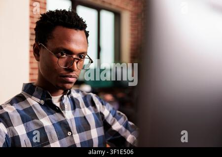 System engineers type JavaScript code in a terminal window, working on software development and screen-based programming tasks, connecting paperwork, planning and professional workflow. Stock Photo