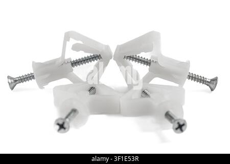 White plastic wall anchors with metal screws. Clean studio shot on pure white background. Ideal for DIY, construction, or home improvement projects. S Stock Photo