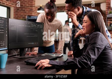 Diverse programming engineers talking about html script, looking at code on computer, working on server interface development, tech engineers parsing cloud computing project with big data in it. Stock Photo