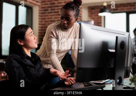 Worried cyber security team members thinking of methods to update defence system without turning it off, software engineers developing cloud storage network and intelligent algorithm. Stock Photo