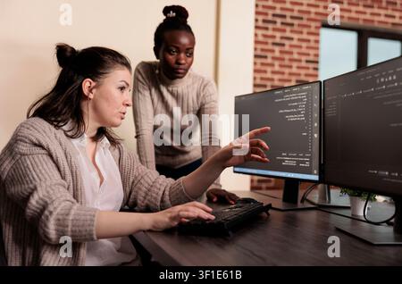 Team of software developers talking about programming in it development agency, Artificial intelligence cloud programers compiling app language innovating online server algorithms. Stock Photo