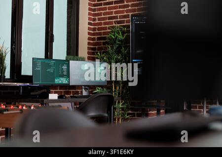 Empty server room with modern hardware in brick wall office while working with code, screens and digital infrastructure for software development. Stock Photo