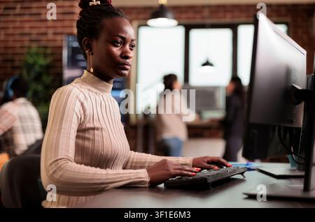 Software developer typing HTML terminal code in server room while working with code, screens and digital infrastructure for software development. Stock Photo