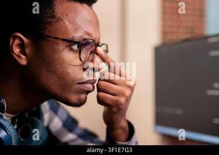 Software developer typing machine learning server code on computer, sitting at desk in software company. Programming engineer working on database system with coding script in it agency. Stock Photo