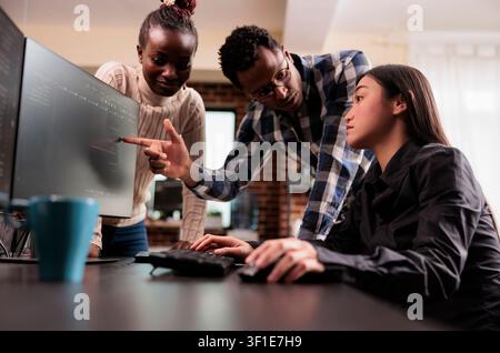 Diverse software developer analyzing html script information on programming computer, parsing source code in it data agency. Tech enginners compiling app language innovating online server algorithms. Stock Photo