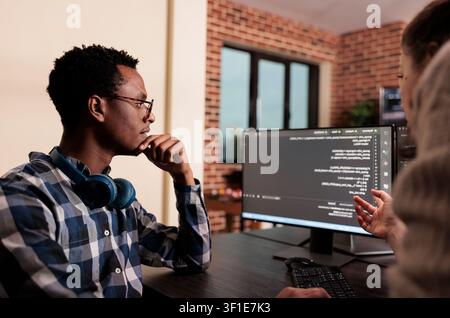 Diverse technology engineers develop a machine learning algorithm, collaborating on programming, data processing and software innovation. Stock Photo