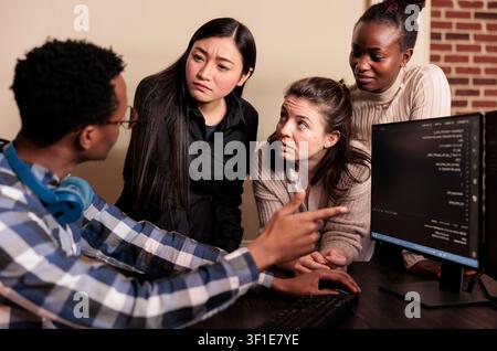 Diverse developers program business application, diverse software developers programming application, typing html code on computer. Stock Photo