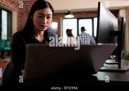 Asian developer building autonomous security system highlighting using advanced artificial intelligence technology, Cyber officer encrypting big chunks of data in order to secure important files. Stock Photo