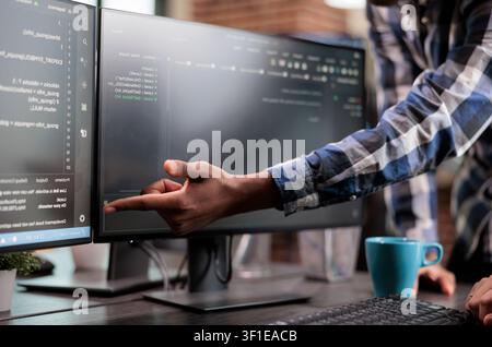 Blockchain engineer points out a mistake in network security code, showing software development, system updates and technical problem solving. Stock Photo