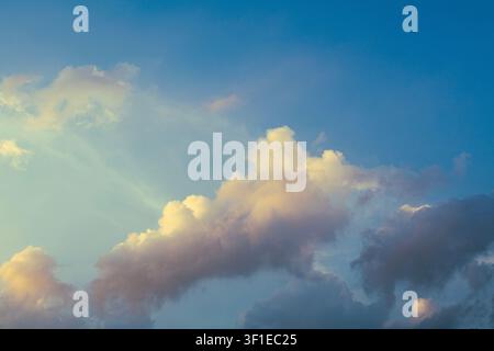 Dramatic Golden Sunset Clouds with Sun Rays Breaking Through Stormy Sky Stock Photo