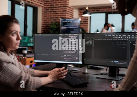 Programming team searches for cyber attack sources and security coverage while developing encryption applications for stronger system protection. Stock Photo
